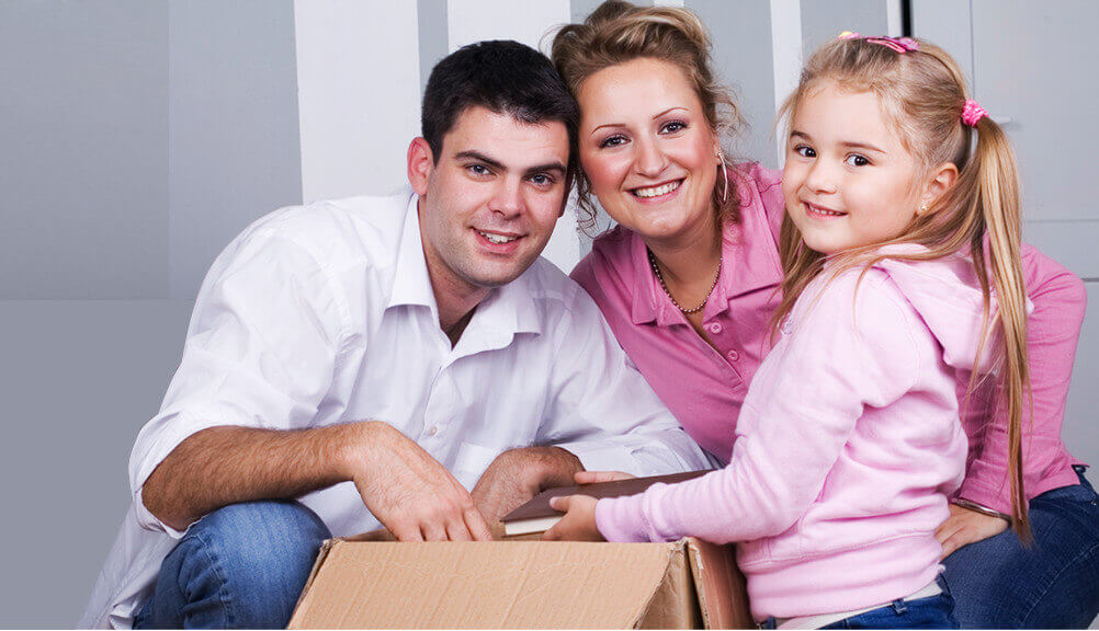 Happy Brisbane family with moving boxes